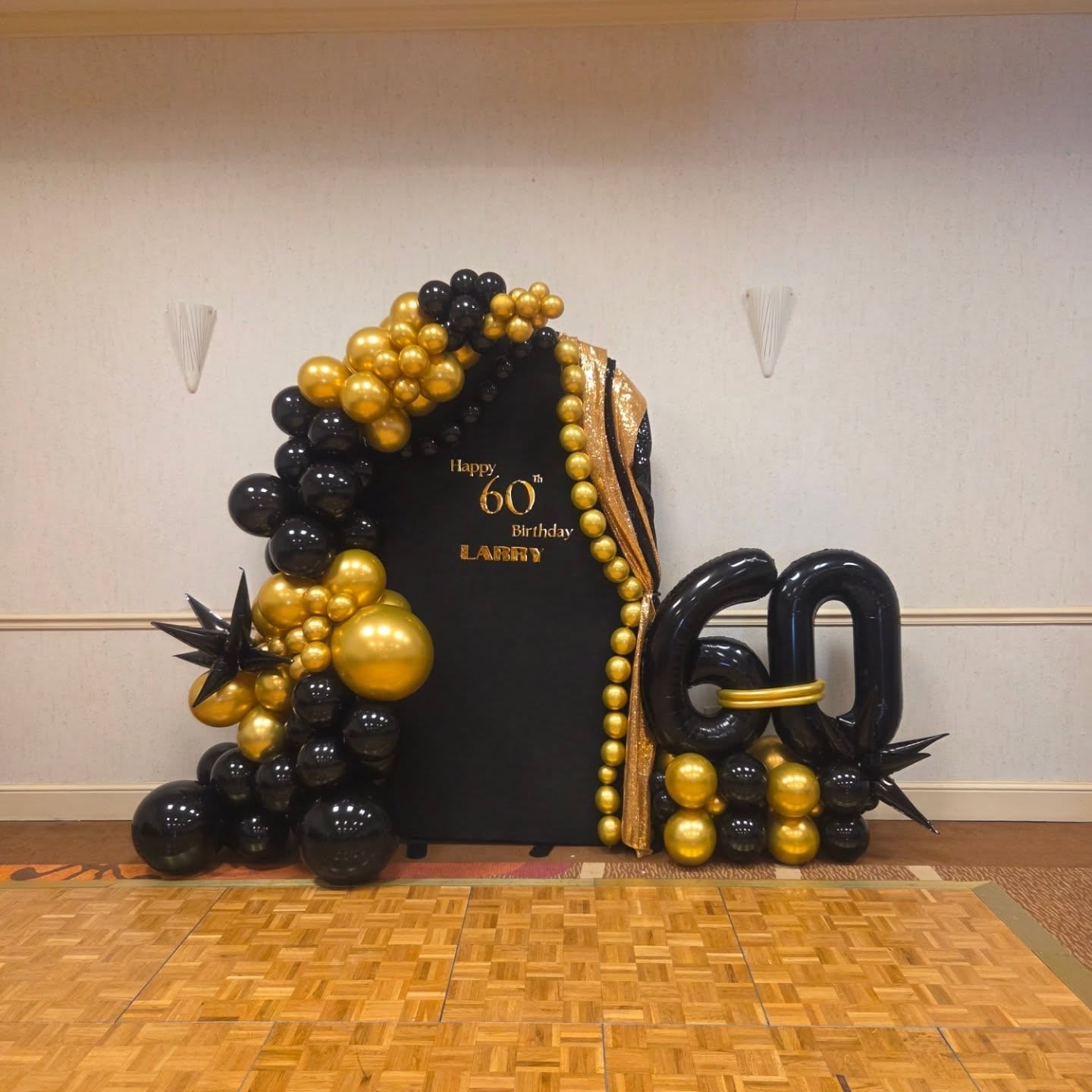 Black and gold balloon backdrop for a formal event
